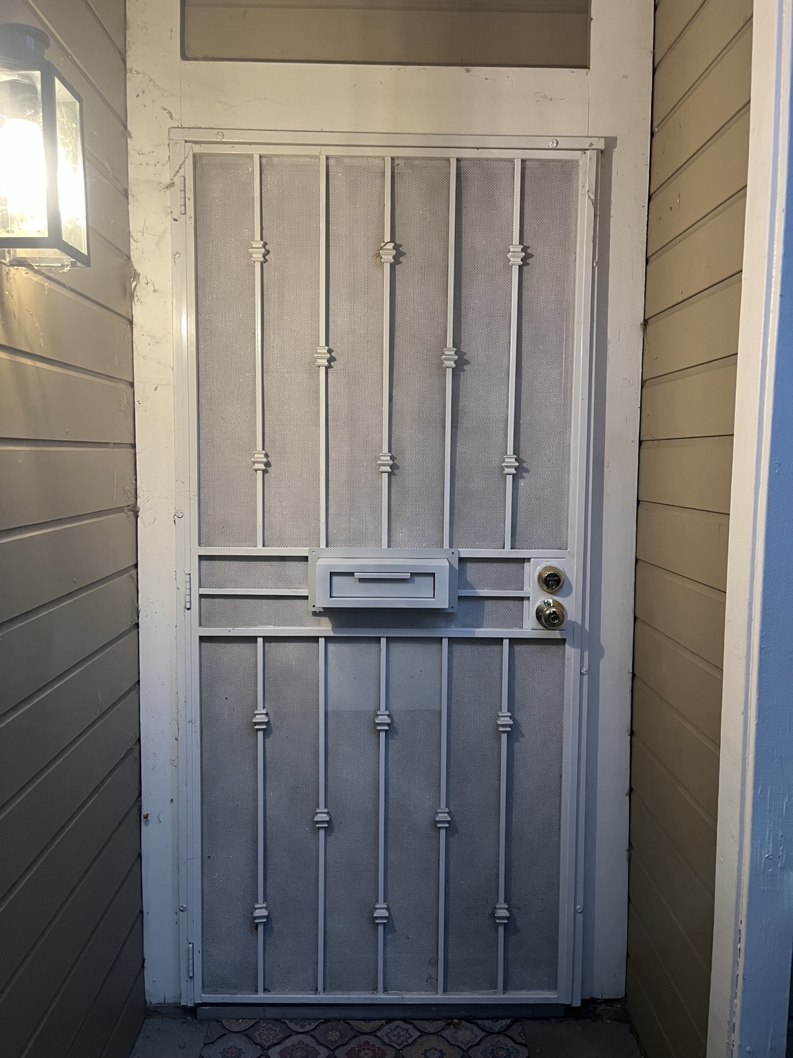 Finished mailbox fitted into a metal security door and painted to match